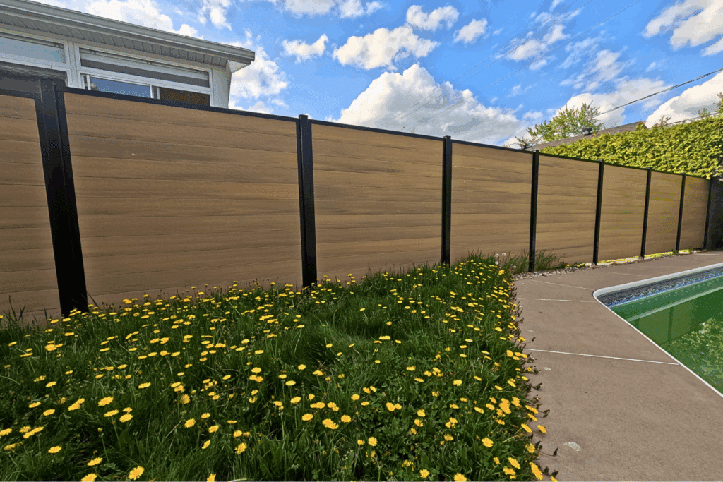 Natural Wood Composite Privacy Fence | FiberWood Fiberwood composite privacy fence in natural wood finish installed near a backyard pool