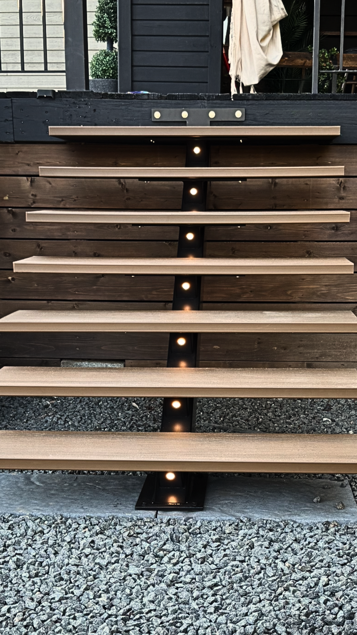 Modern Staircase with Natural Wood-Style Composite Treads | FiberWood Open-riser staircase with natural wood-style composite treads and integrated lighting, ideal for composite decking installations
